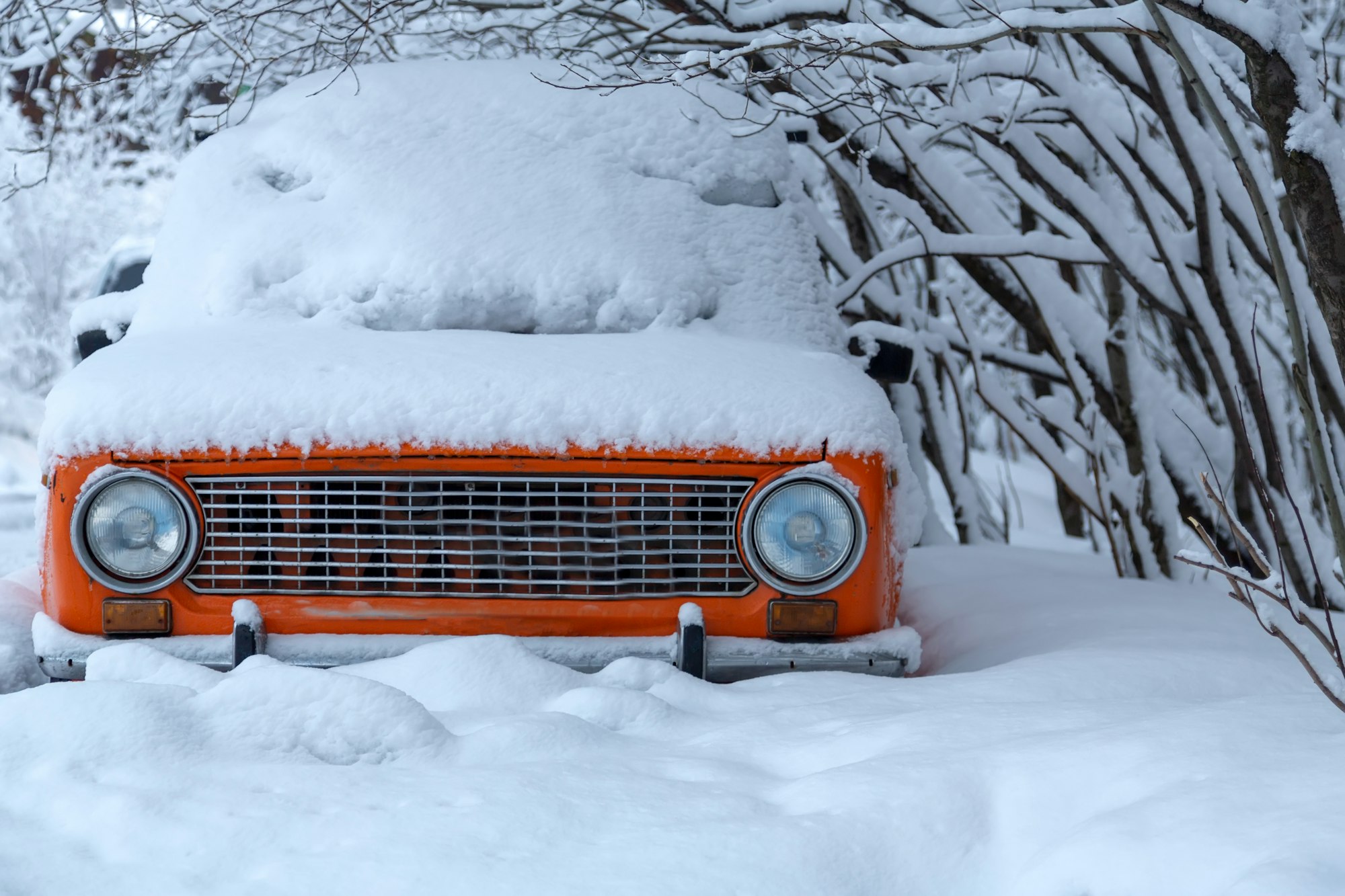 Red car under the snow